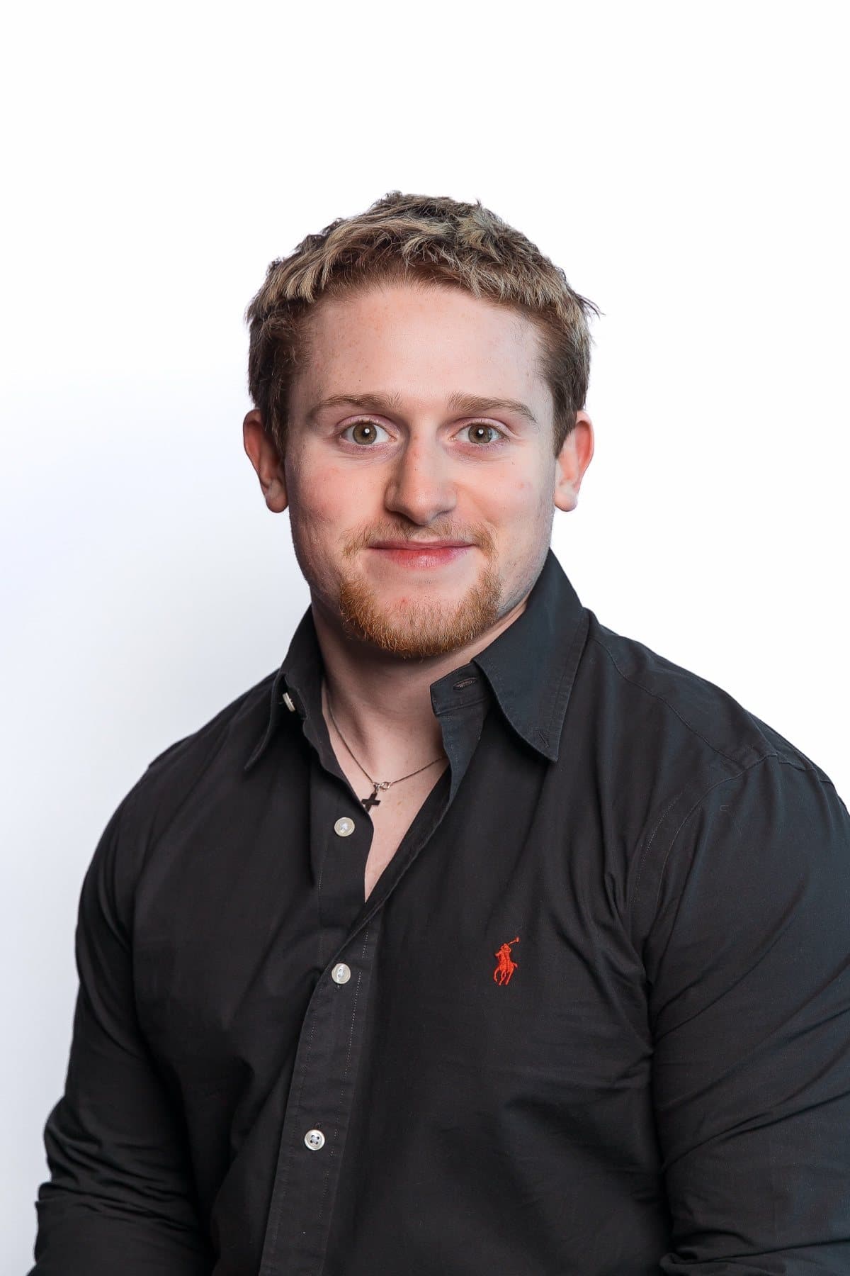 Kenny Sippel, studio portrait in a black shirt, January 2024.